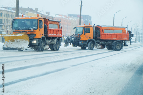 snowplow on snow-covered roads of the city
