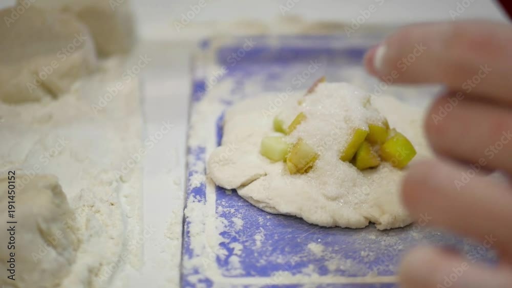 Home food. Making dough by female hands on kitchen table. Hands kneading dough on white table Home food. Making dough by female hands on kitchen table. Hands kneading dough on white table