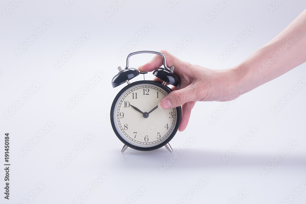 alarm clock with hand. alarm clock with hand on the background. alarm clock with hand. alarm clock with hand on the background.