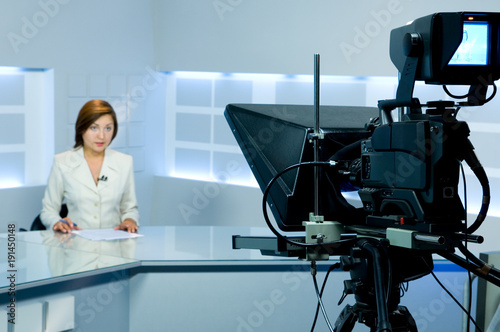 television anchorwoman during live broadcasting photo