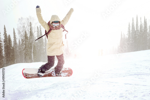 Sheregesh, Kemerovo region, Russia - January, 2018: Girl with snowboards on the mountain. Woman snowboarding in the winter. photo