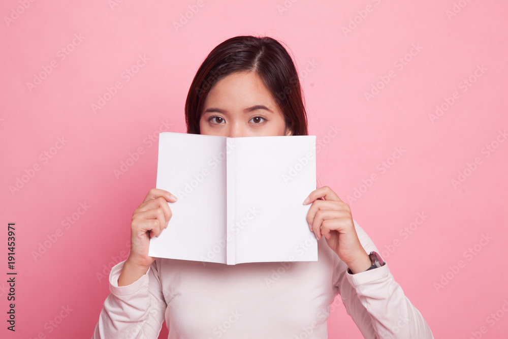 Young Asian woman with a book. Young Asian woman with a book.