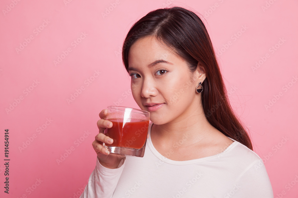 Young Asian woman drink tomato juice. Young Asian woman drink tomato juice.
