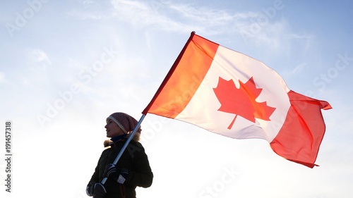 Man on the top with Canadian flag. Winner and motivation concept