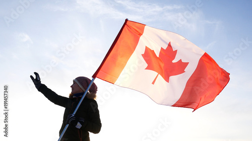Man on the top with Canadian flag. Winner and motivation concept