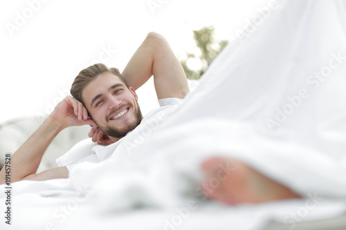 closeup.smiling man resting in the bedroom