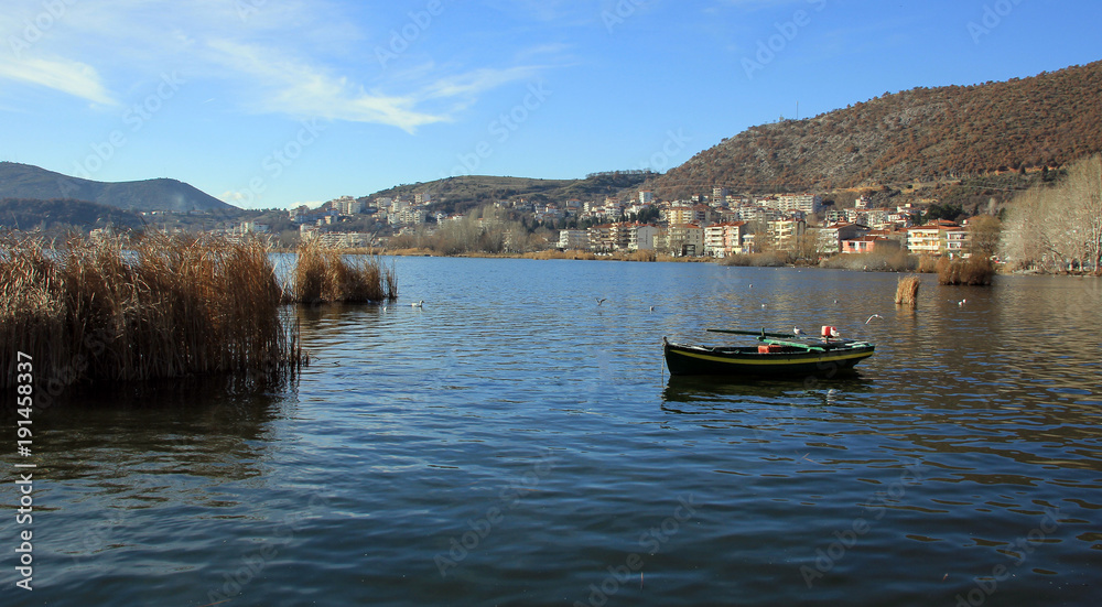 Old wooden boat on Orestiada lake in Kastoria town, Greece