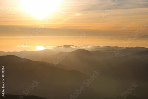 beautiful view of the sun reflected in the sea from ligurian mountains