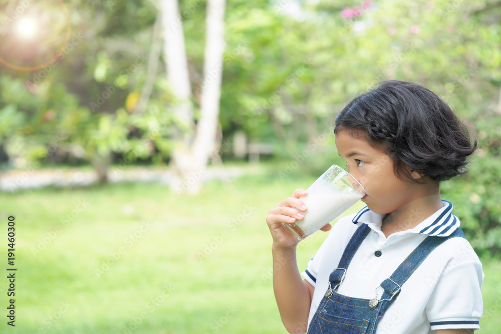Girl children drinking milk at the park for breakfast. Girl children drinking milk at the park for breakfast.