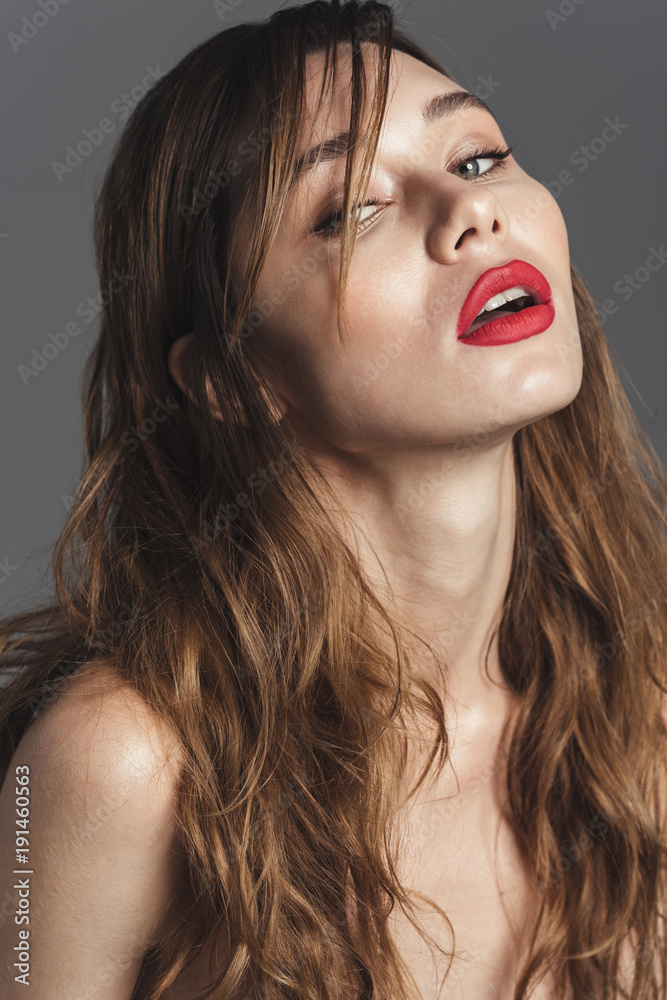 Fashion portrait of a sexy curly brown hair woman with makeup Fashion portrait of a sexy curly brown hair woman with makeup