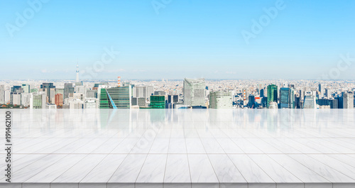 Fototapeta Naklejka Na Ścianę i Meble -  Business concept - Empty marble floor top with panoramic modern cityscape building bird eye aerial view under sunrise and morning bright sky of Tokyo, Japan, for display or montage product.