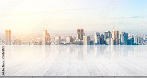 Business concept - Empty marble floor top with panoramic modern cityscape building bird eye aerial view under sunrise and morning bright sky of Tokyo, Japan, for display or montage product.