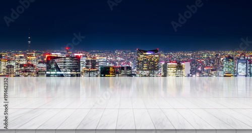 Business concept - Empty marble floor top with panoramic modern cityscape building bird eye aerial view under sunrise and morning bright sky of Tokyo, Japan, for display or montage product.