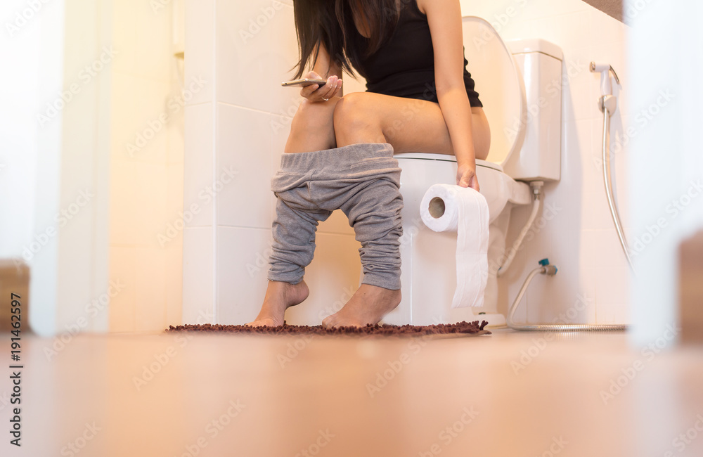 Woman using toilet after wake up in the morning,Pants is hanging on legs  Stock Photo | Adobe Stock