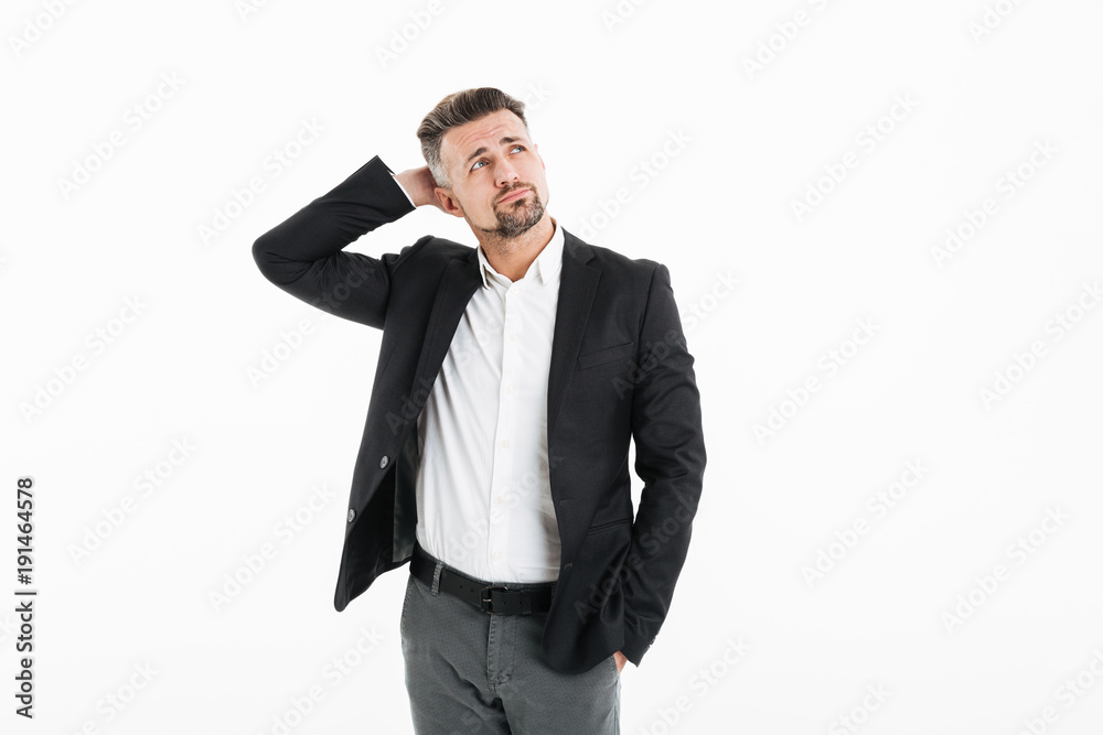 Portrait of man in office wearing jacket looking aside and touching his head, isolated over white background Portrait of man in office wearing jacket looking aside and touching his head, isolated over white background