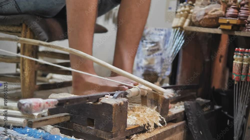 Morocco, Man using bow lathe tool to smooth out cylindrical piece of wood Morocco, Man using bow lathe tool to smooth out cylindrical piece of wood