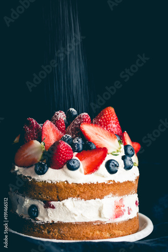 Sponge cake with strawberries, blueberries and cream