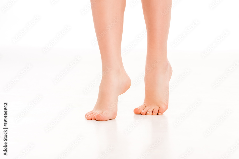 low section of barefoot female legs, isolated on white low section of barefoot female legs, isolated on white