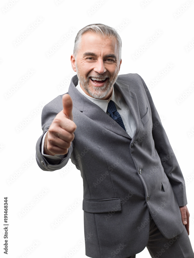 Confident business executive giving a thumbs up Confident business executive giving a thumbs up