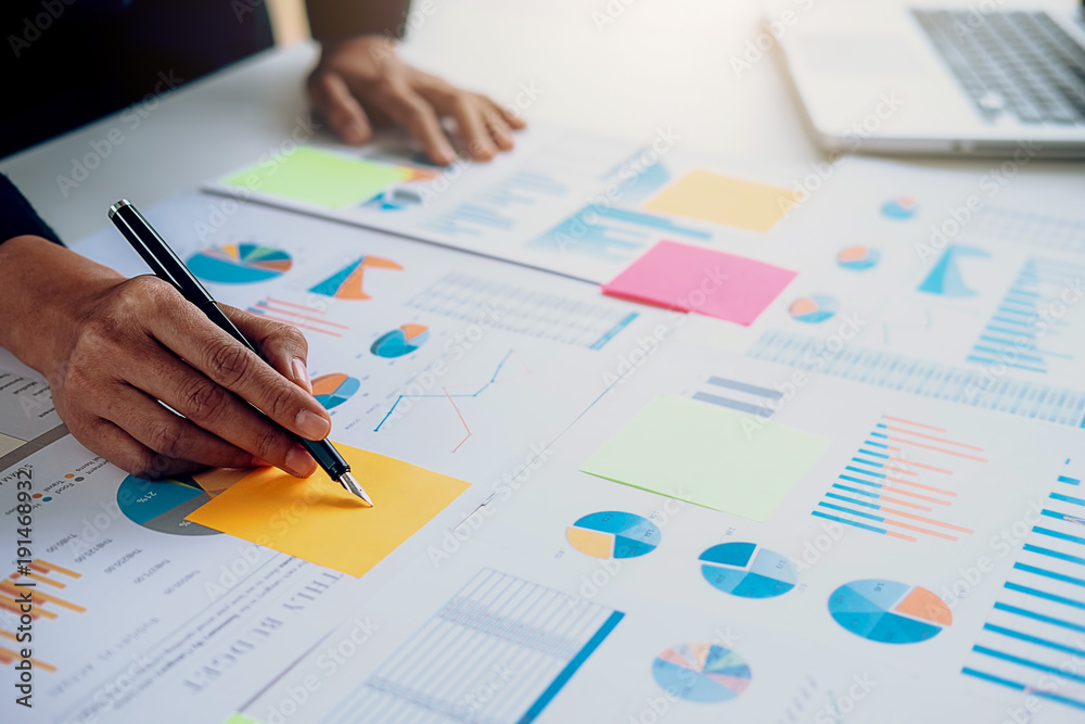 Business concept. Business people discussing the charts and graphs showing the results of their successful teamwork. Business concept. Business people discussing the charts and graphs showing the results of their successful teamwork.