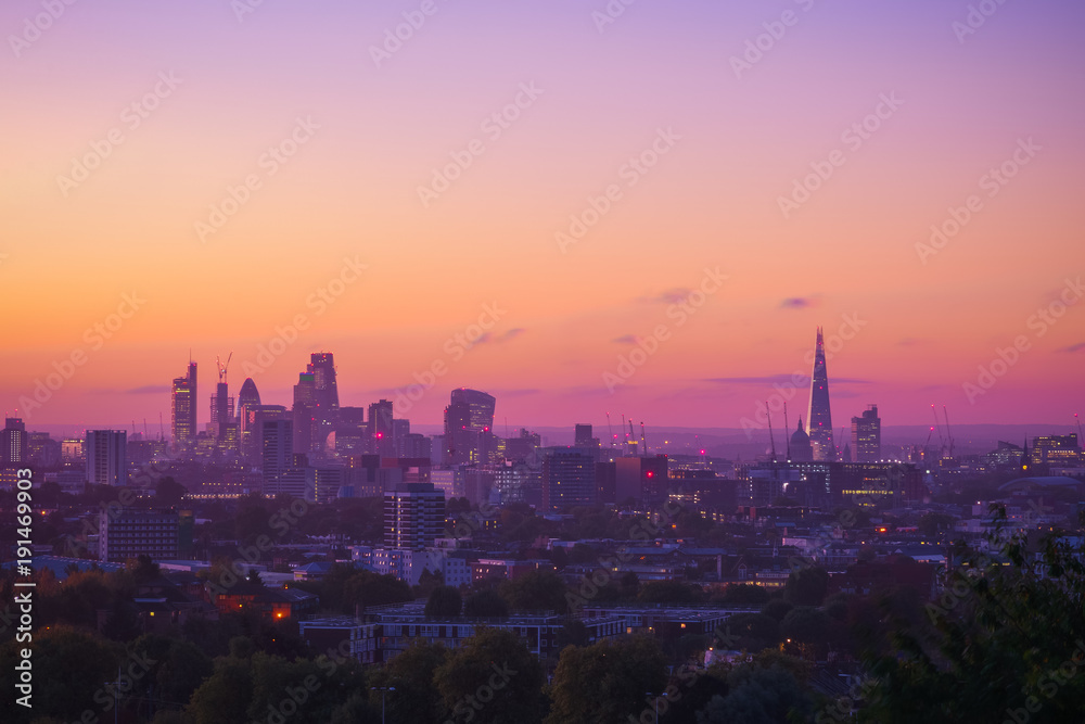 View towards London city skyline at sunrise from Parliament Hill in Hampstead Heath