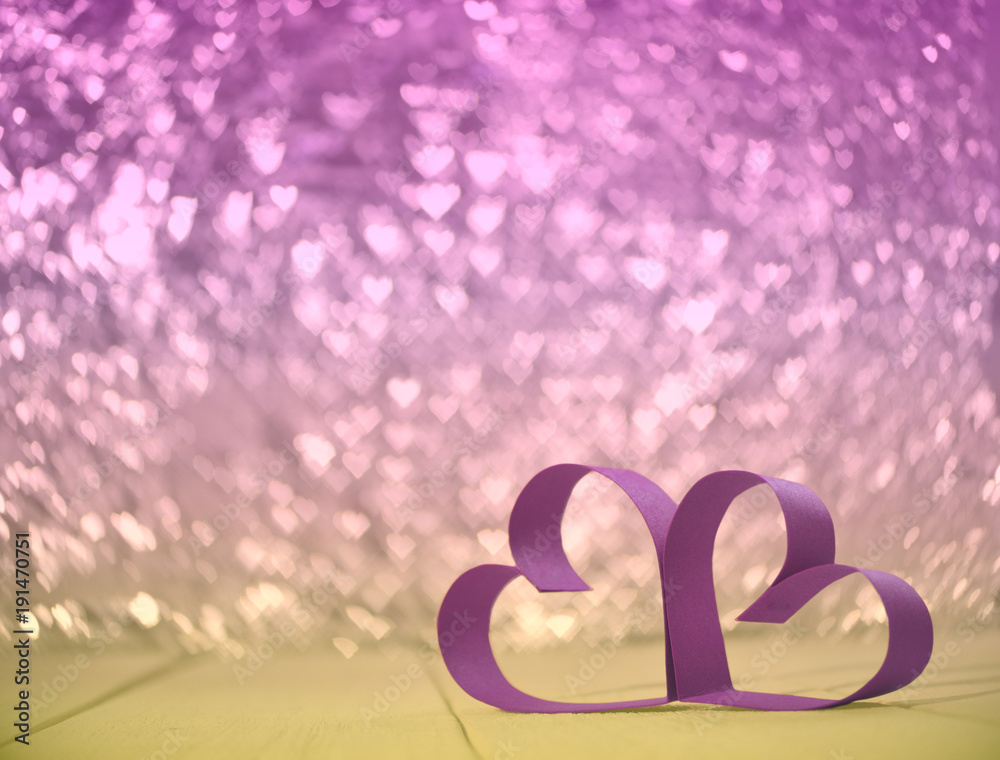 valentines. wedding concept. heart bokeh. couple of pink hearts on pink and yellow bokeh in shape of hearts background