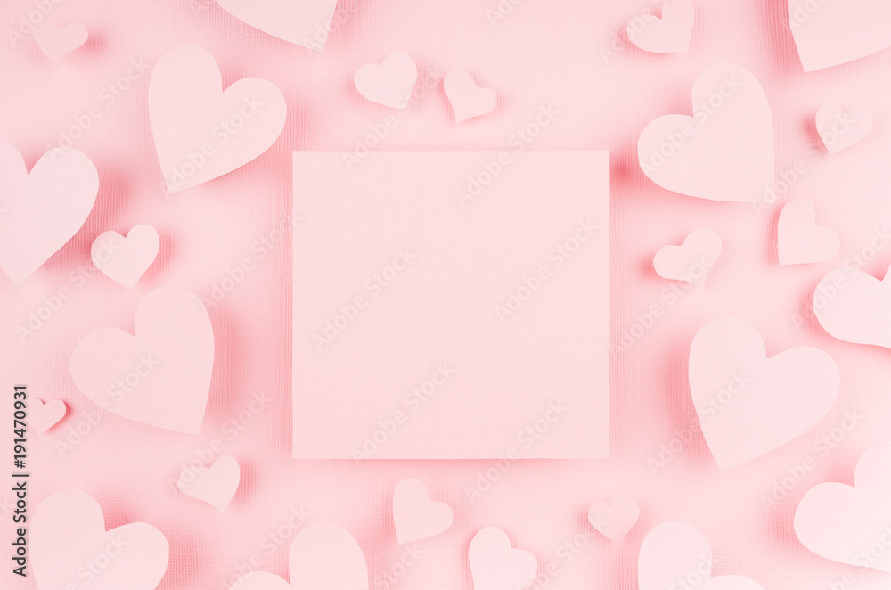 Blank pink square page with paper hearts on light background. Advertesign concept for Valentine day.