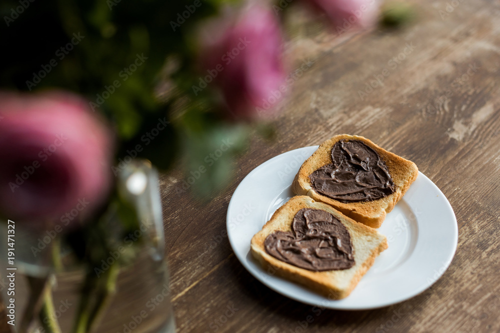 toasts with chocolate paste in shape of hearts on wooden table, valentines day concept toasts with chocolate paste in shape of hearts on wooden table, valentines day concept