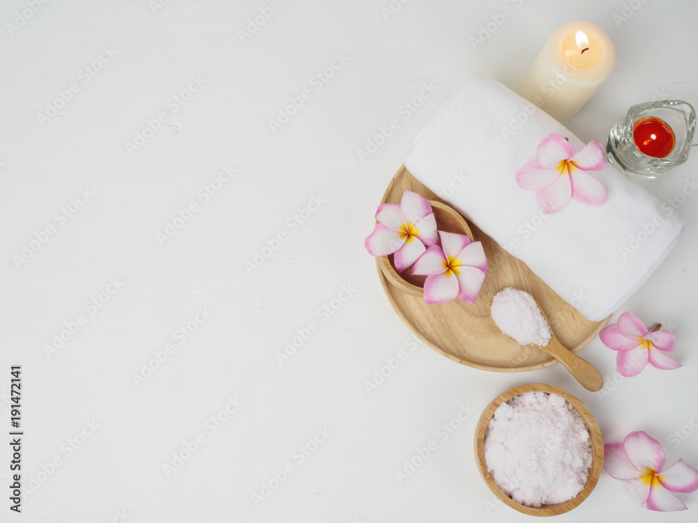 spa wellness set.beauty and fashion set on the white table.spa towel with candle and plumeria, tree on the white table. spa wellness set.beauty and fashion set on the white table.spa towel with candle and plumeria, tree on the white table.