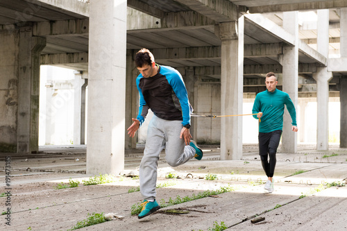 Young handsome athlete men doing exercise  in an old abandoned building outdoor © Dusan Kostic