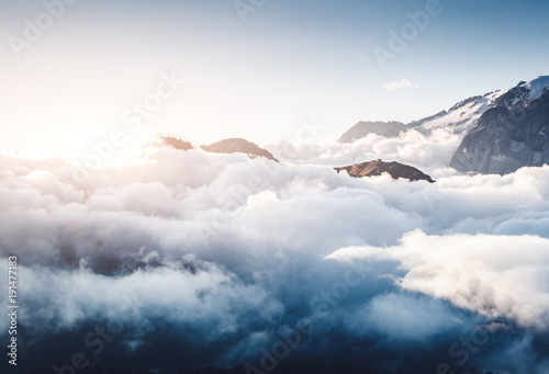 Creamy fog covered the glacier Marmolada. Location place Val di Fassa valley, passo Sella, Dolomiti, Italy.