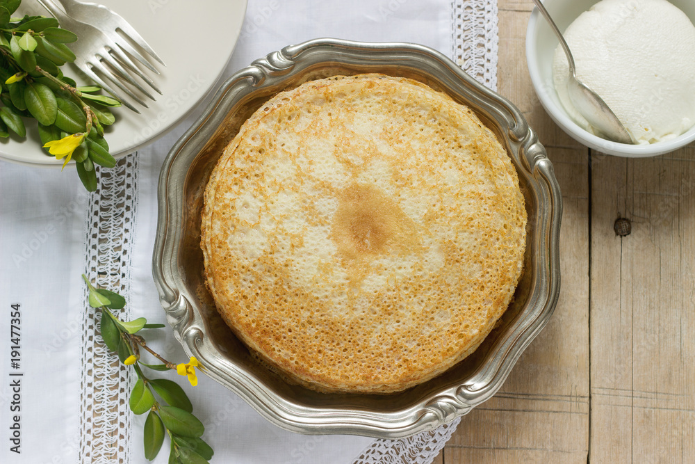 Delicate fishnet pancakes with sour cream. Delicate fishnet pancakes with sour cream.