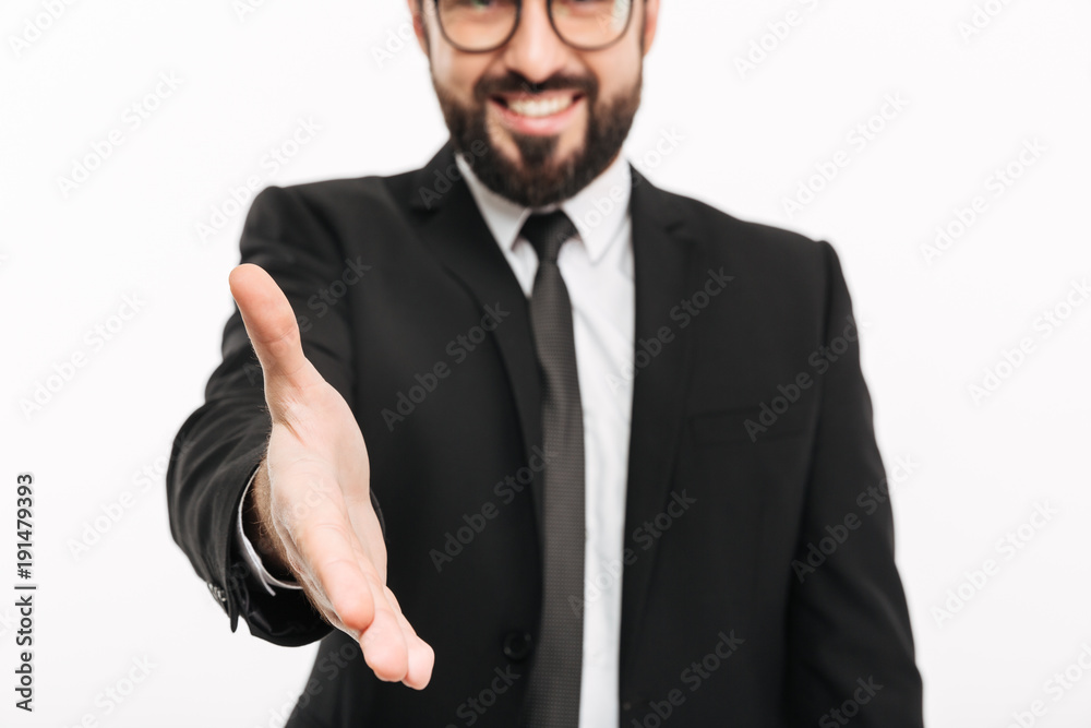 Cropped photo of cheerful businessman in suit and eyeglasses shaking hand while attending meeting or job interview, isolated over white background Cropped photo of cheerful businessman in suit and eyeglasses shaking hand while attending meeting or job interview, isolated over white background
