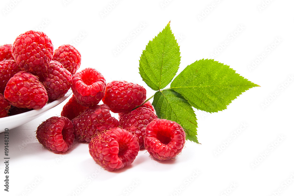 Small plate with ripe raspberries and green leaf isolated on white background. Small plate with ripe raspberries and green leaf isolated on white background.