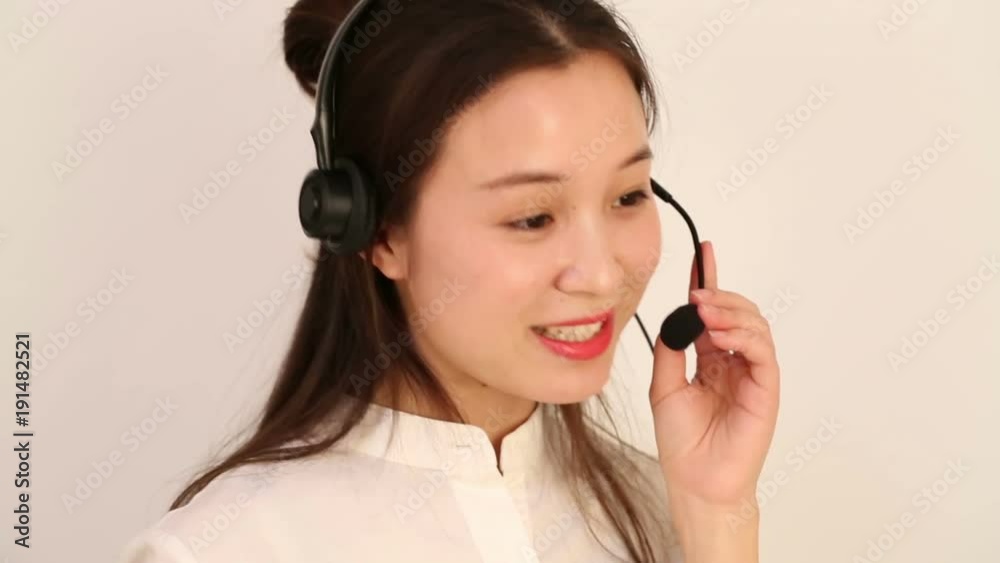 Customer service and support woman talking on the phone against a white background Customer service and support woman talking on the phone against a white background