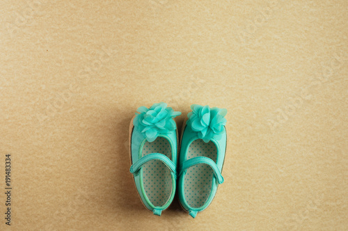 Shoes for baby girl on beige background with copy space