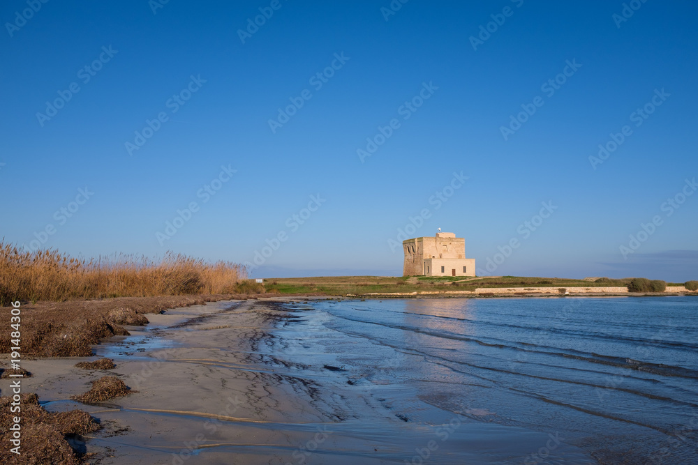 XVI Century antique defensive tower Torre Guaceto along the coast of Apulia. Italy
