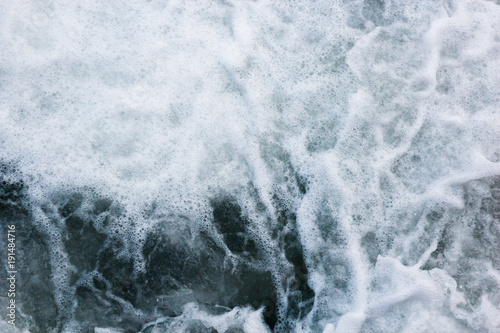 Sea waves raging and splashing, abstract aqua background
