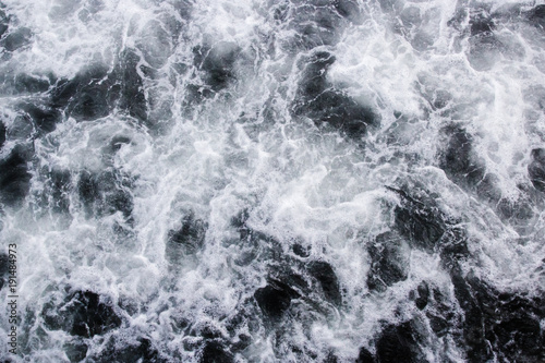 Sea waves raging and splashing, abstract black and white background