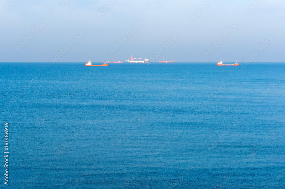 The calm sea. Ships on the horizon. Sea surface.