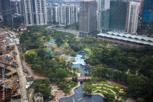 Urban views of Kuala Lumpur with tall skyscrapers, drowning in the greenery of parks