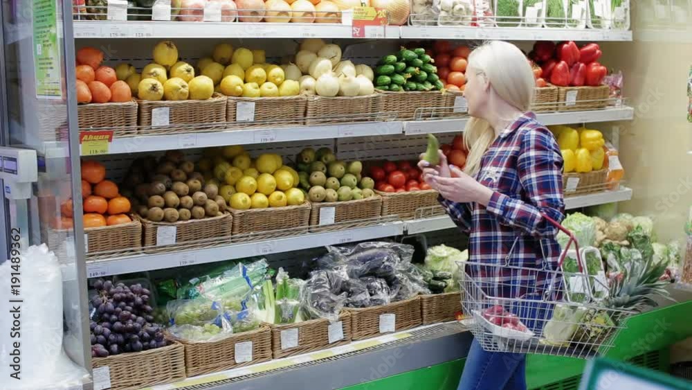 woman takes fruit in a supermarket woman takes fruit in a supermarket