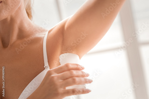 Fresh deodorant. Close up of a fresh deodorant being applied on an female armpit