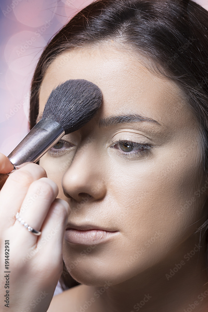 beautiful girl applying makeup with brush.getting ready for valentines day beautiful girl applying makeup with brush.getting ready for valentines day