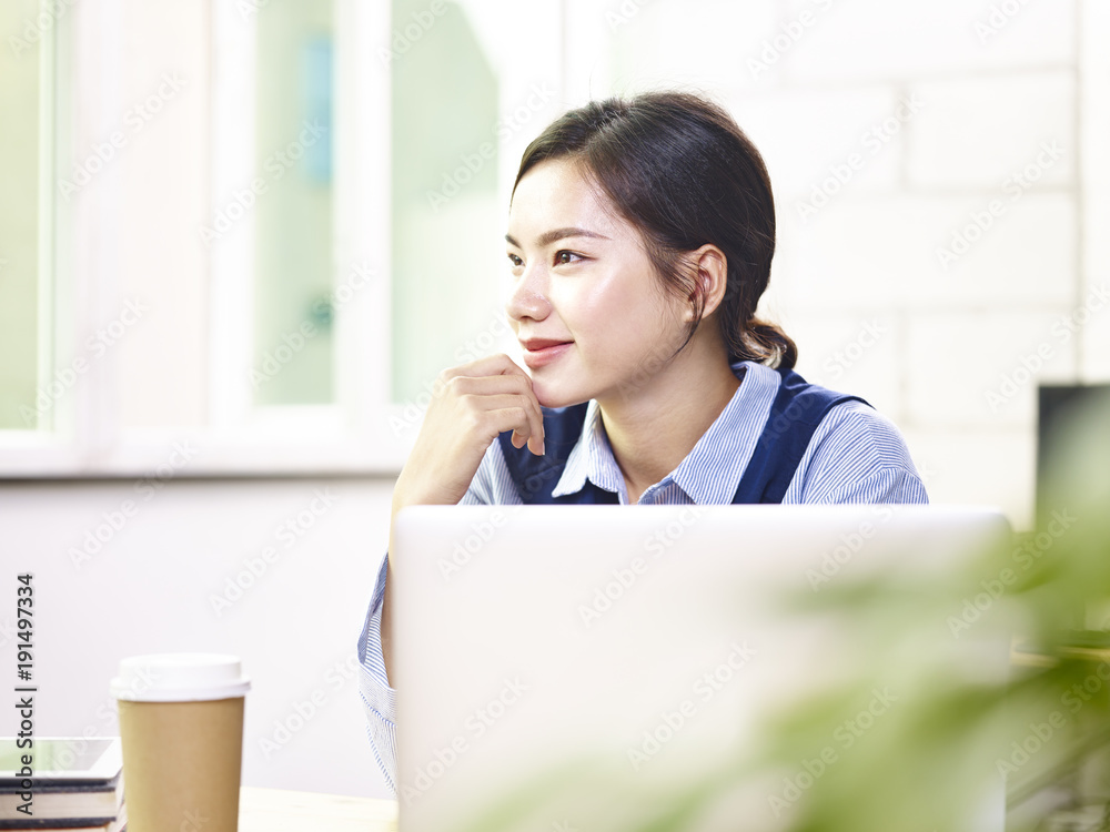 young asian business woman thinking in office young asian business woman thinking in office