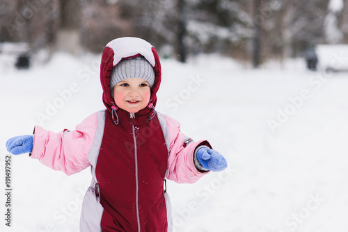 kid playing in the park in winter