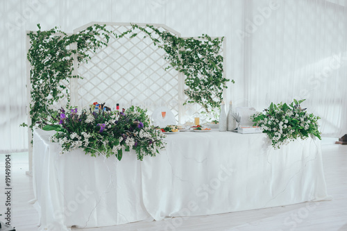Beautiful wedding ceremony outdoors. Arch made of natural flowers. Decor photo