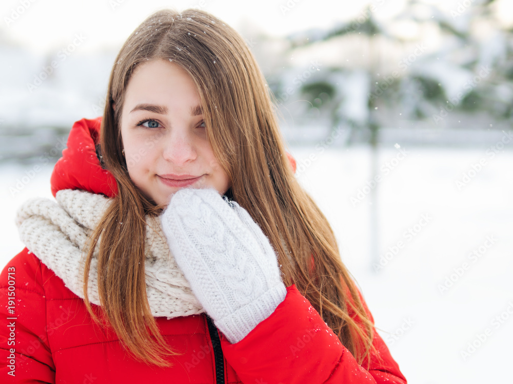 Winter portrait of a cute young woman in white mittens in the cold Winter portrait of a cute young woman in white mittens in the cold