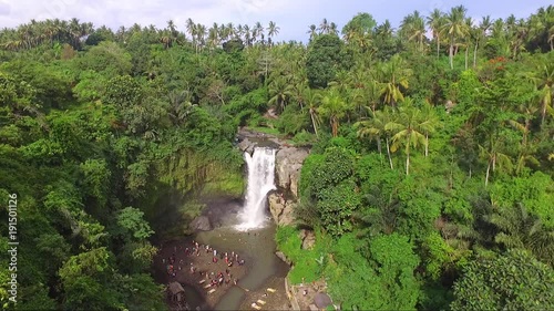 Drone shot of people enjoying in Tegunungan Falls in Indonesia photo