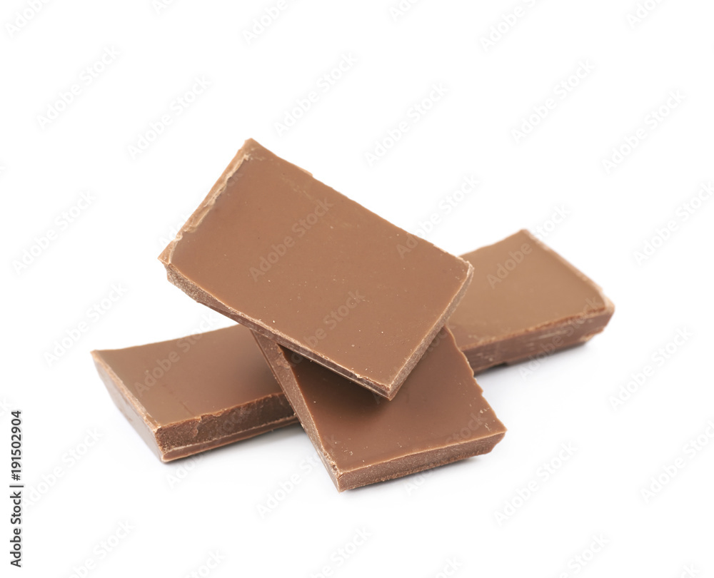 Pile of milk chocolate pieces isolated Pile of milk chocolate pieces isolated